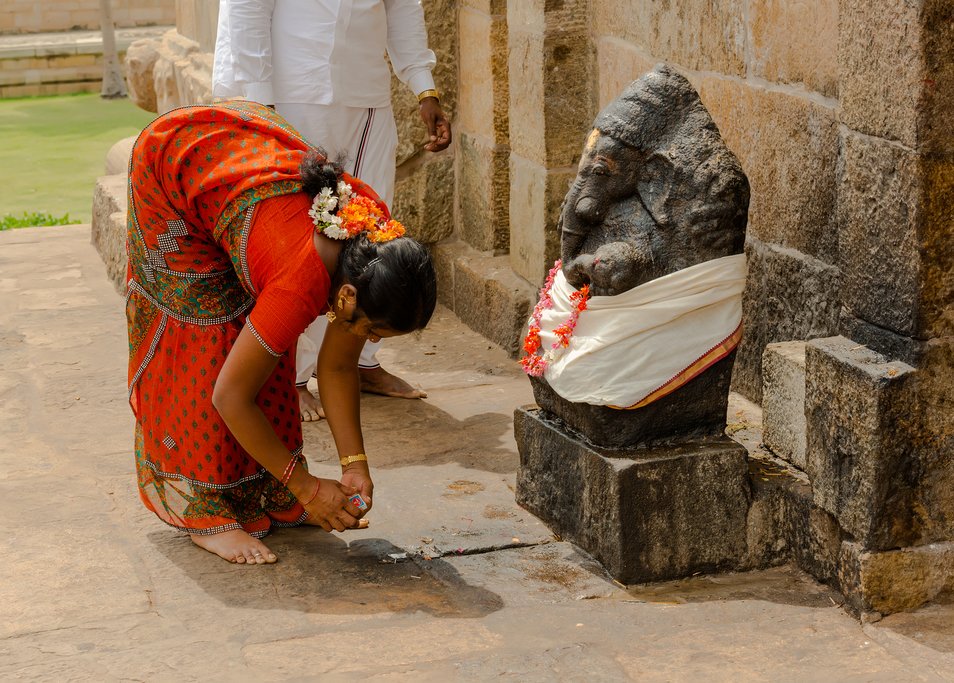 A woman worshipping a Ganesh statue at Tanjore