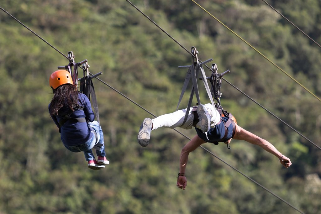 Sliding down a tandem zip line one of many adventures you can have near the city of Baños.