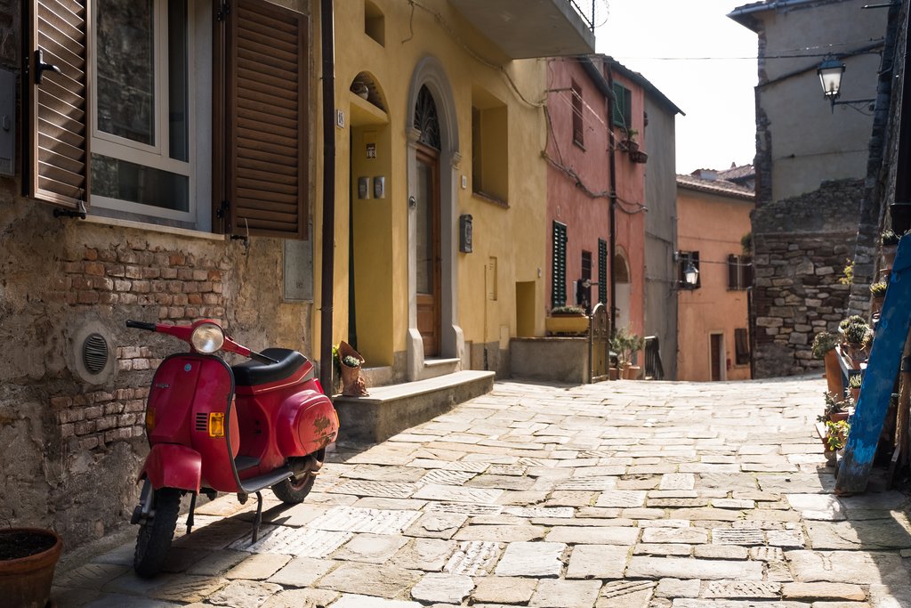 Vespa waiting for adventure in a Tuscan town