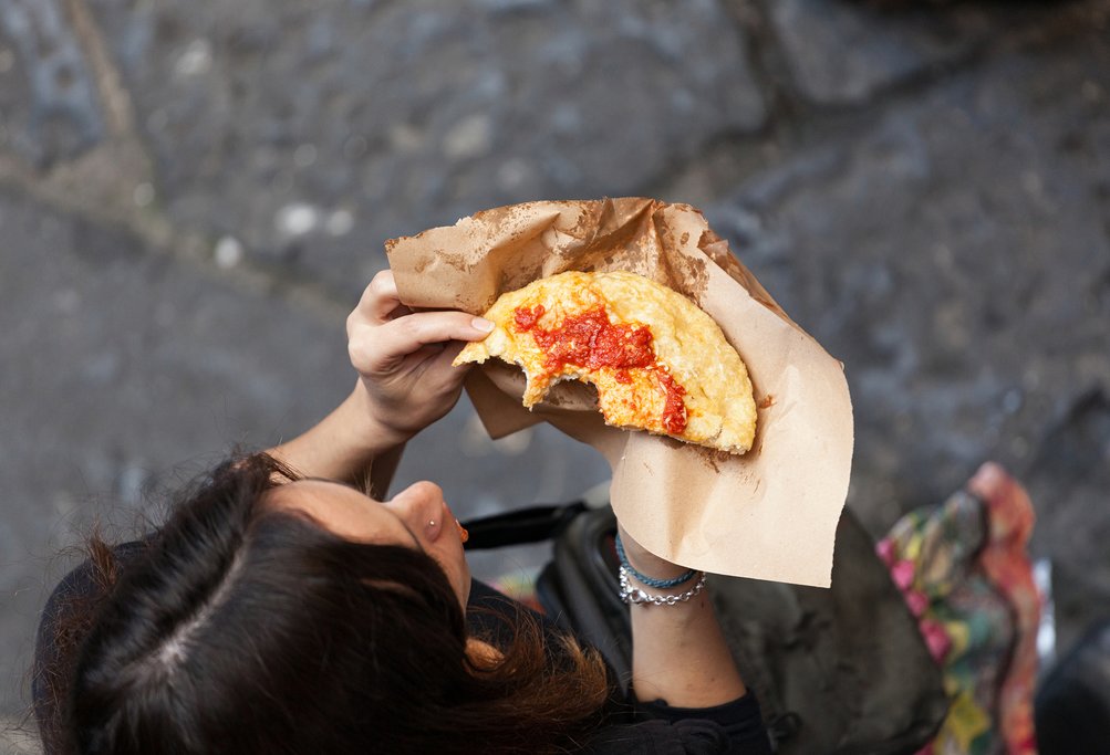 Eating pizza on the street in Naples