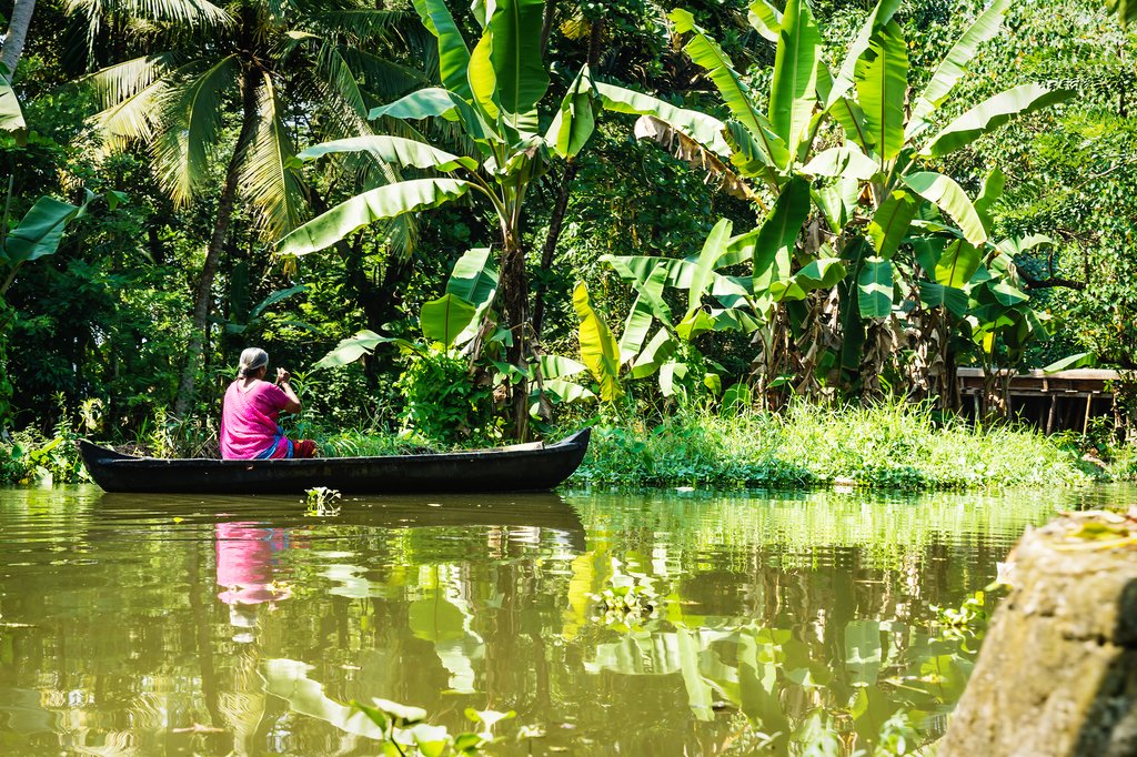 A local paddles a boat in Alleppey