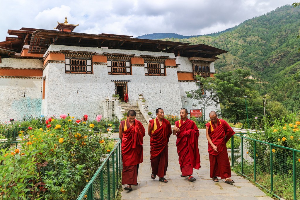 Monks in the garden at Simtokha Dzong in Thimphu
