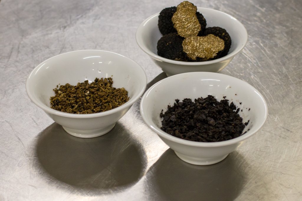 Bowl of whole and minced truffles