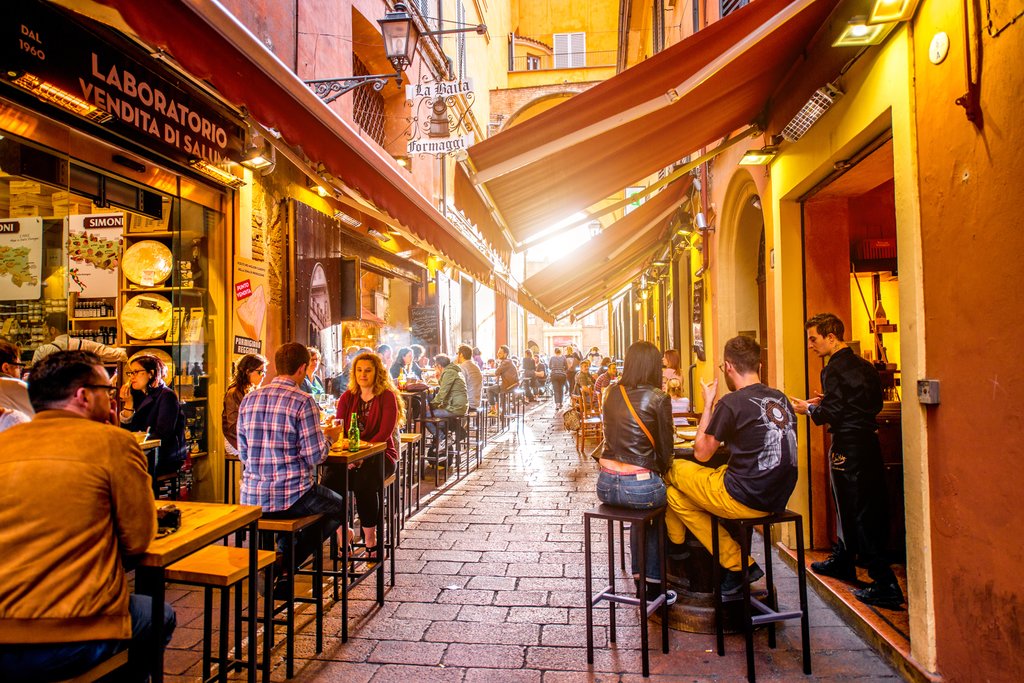 People enjoying lunch on Pescherie Vecchie street near famous food markets and shops