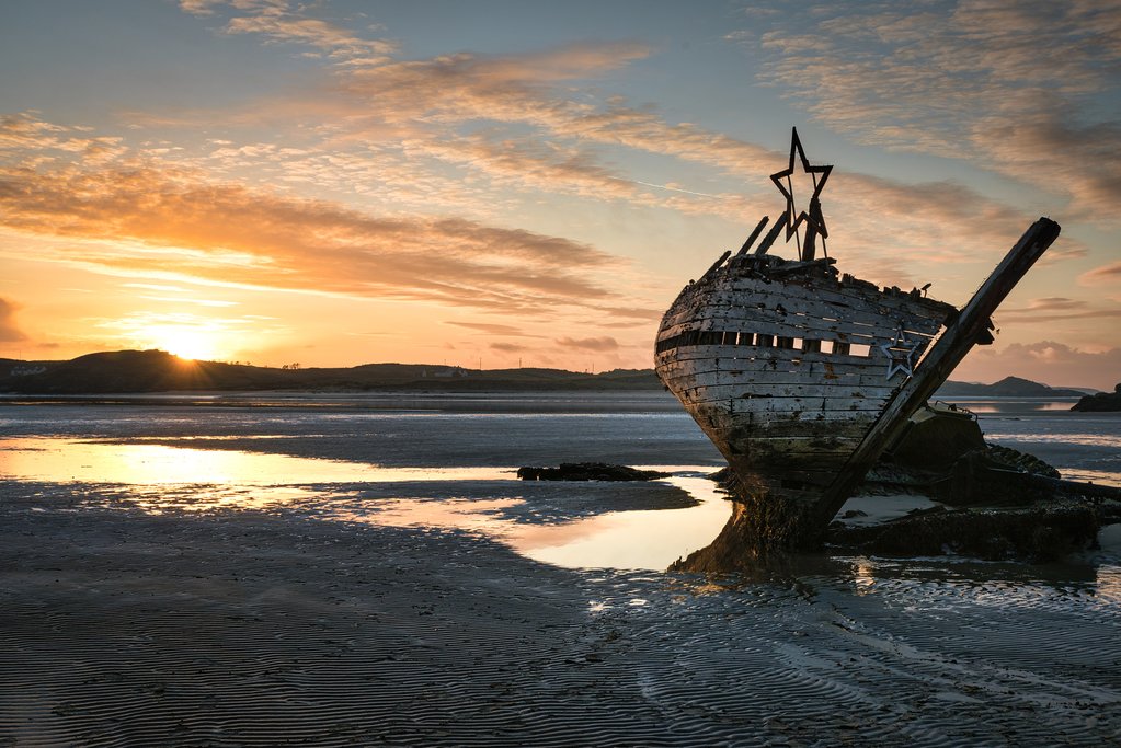 An old shipwreck at sunset in Bunbeg
