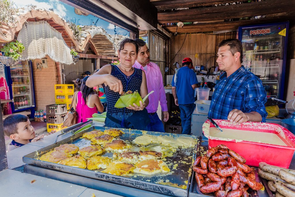 Locals serving up homemade arepas at El Mercado Campesino
