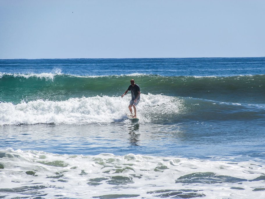 Take a surfing lesson on Domincal Beach
