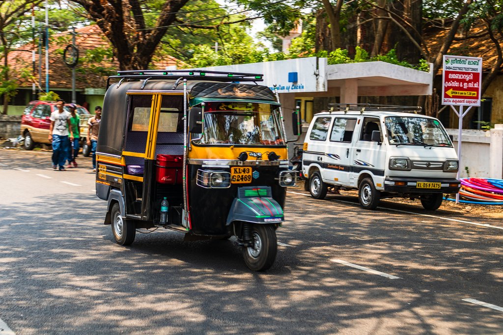 A tuk-tuk whizzing along a street in Cochin