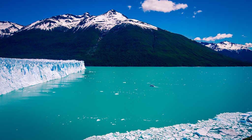 The glacial blue waters surrounding the Glacier reflect the sunlight and seem to glow from within