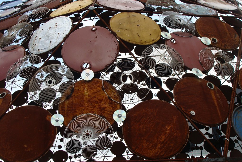 Dome made of repurposed oil drum covers, CDs and electric fans