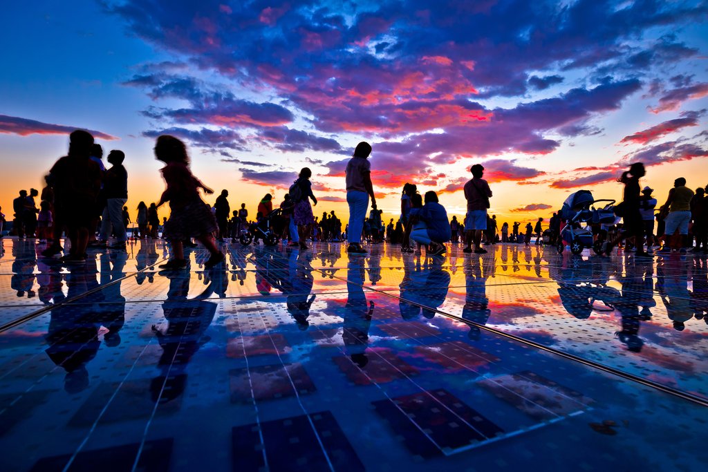 Silhouettes of people on Zadar's Monument to the Sun