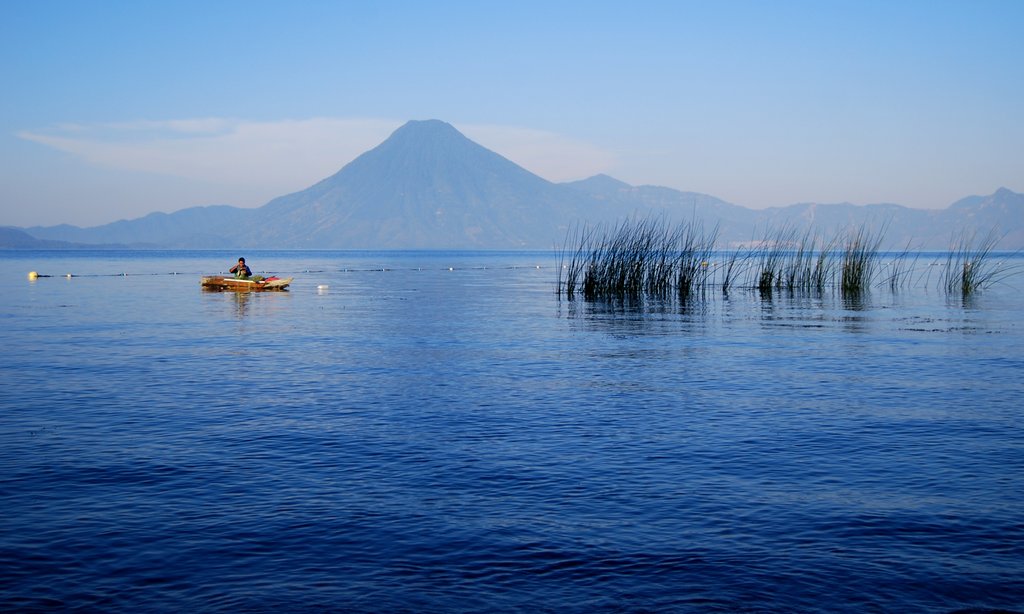 A boat on the azure waters of Lake Atitlan