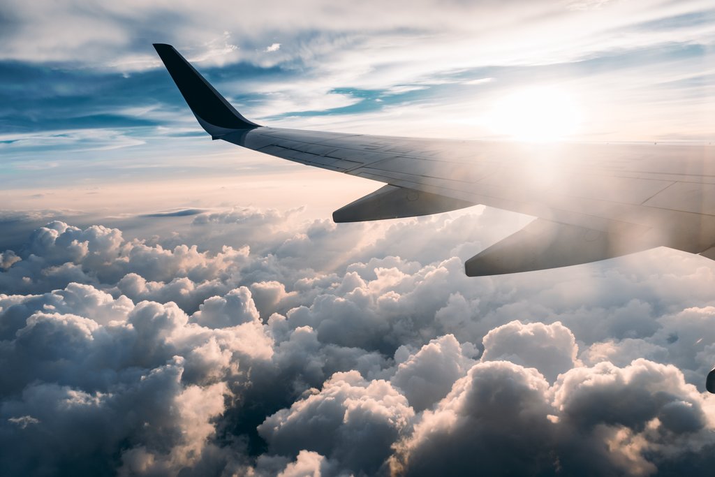 Airplane departing with a view of clouds below