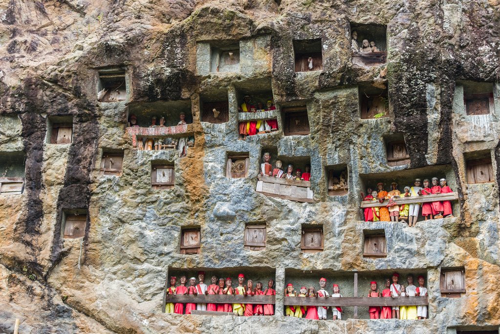 Visit Torajan cliff burial sites with Tau Tau wooden effigies