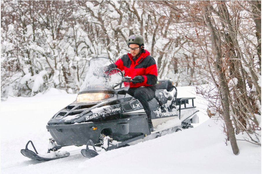 Snowmobile through winter forests and valleys
