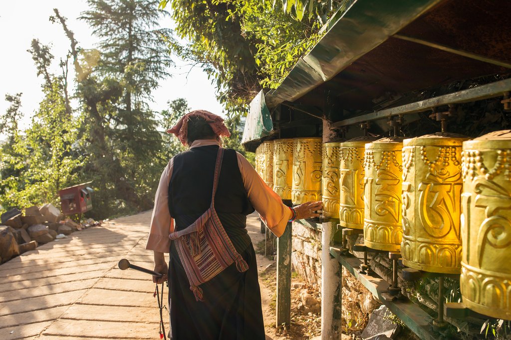 A woman spinning prayer wheels in Namgyal Monastery