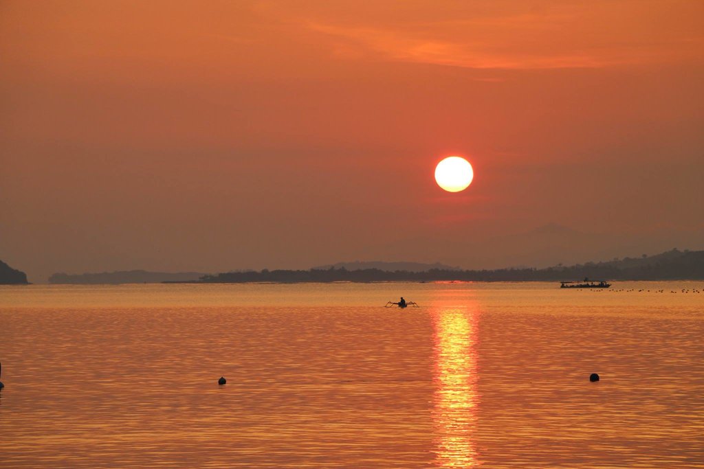 Watch the sun set over the ocean while you sip on a coconut