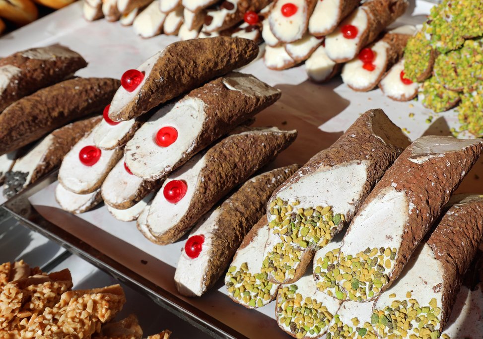 A pastry shop selling cherry and pistachio accented cannoli