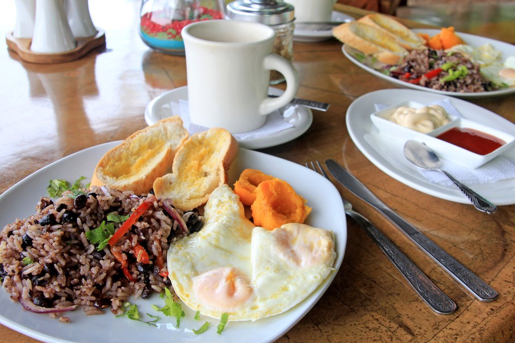 A traditional Costa Rican breakfast with gallo pinto, eggs, and coffee