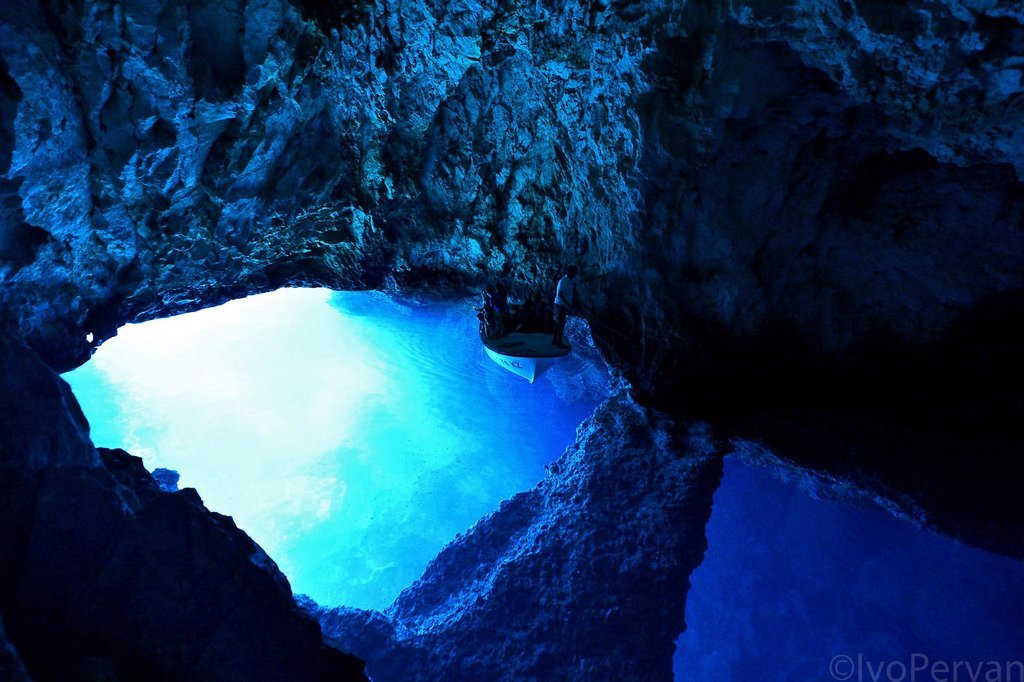 Sunlight beams through an underwater passage and reflects off the sea bottom
