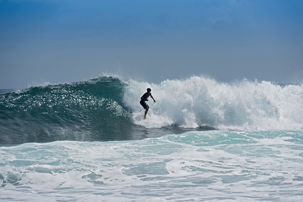 A surfer rides the waves in Puerto Viejo