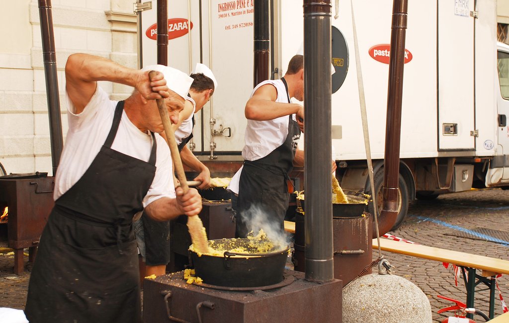 Chefs stirring polenta during the annual Friuli Doc celebration