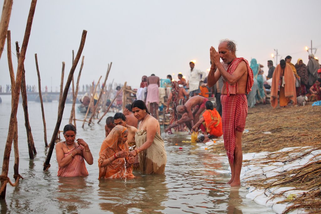 Hindu Pilgrims bathing in the confluence of the three holy rivers