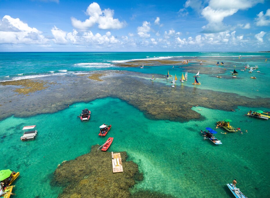 Colorful boats dotting the waters off Porto de Galinhas