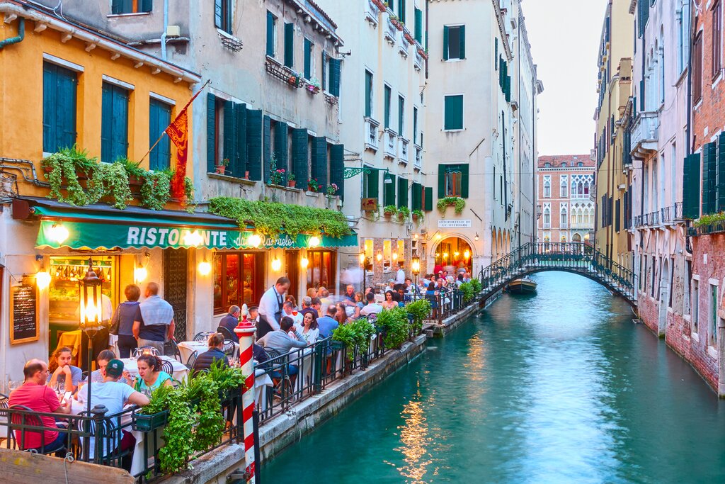 Stroll along the canals and eat delicious seafood in Venice 