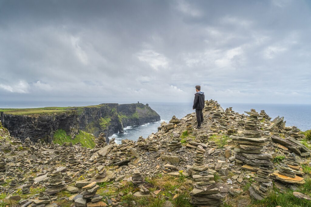Traveler admiring the views of Ireland's coastline