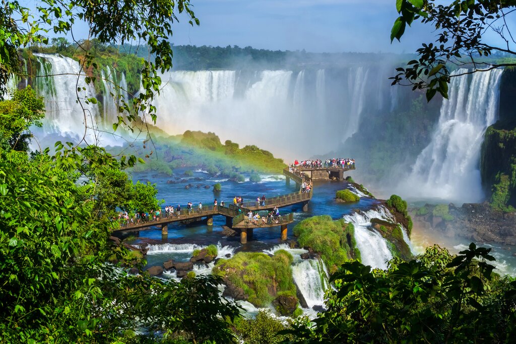 Tourists stand on the walkway on the Brazilian side of Iguazú Falls