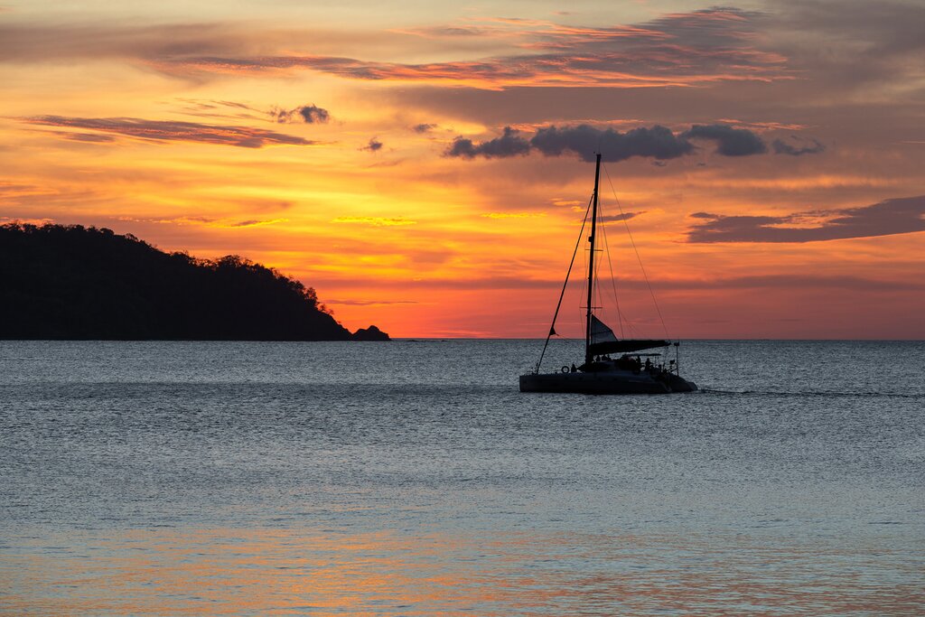 Watch the sunset from the deck of your catamaran as you cruise around the coast