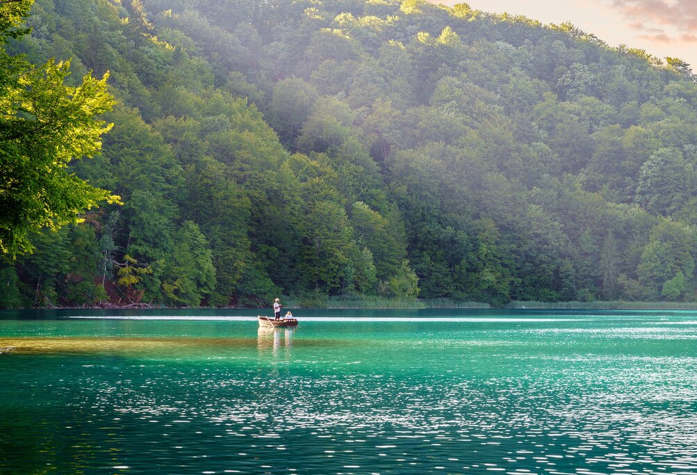 Explore watery landscapes of Plitvice Lakes National Park with a tranquil boat ride