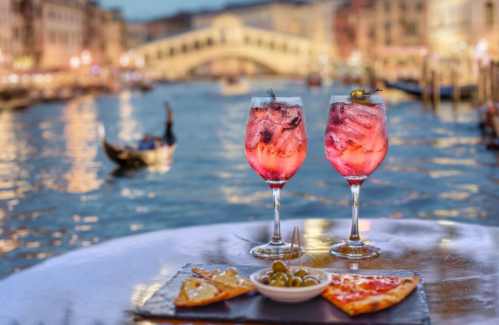 Pink aperitif and appetizers with the Grand Canal in Venice