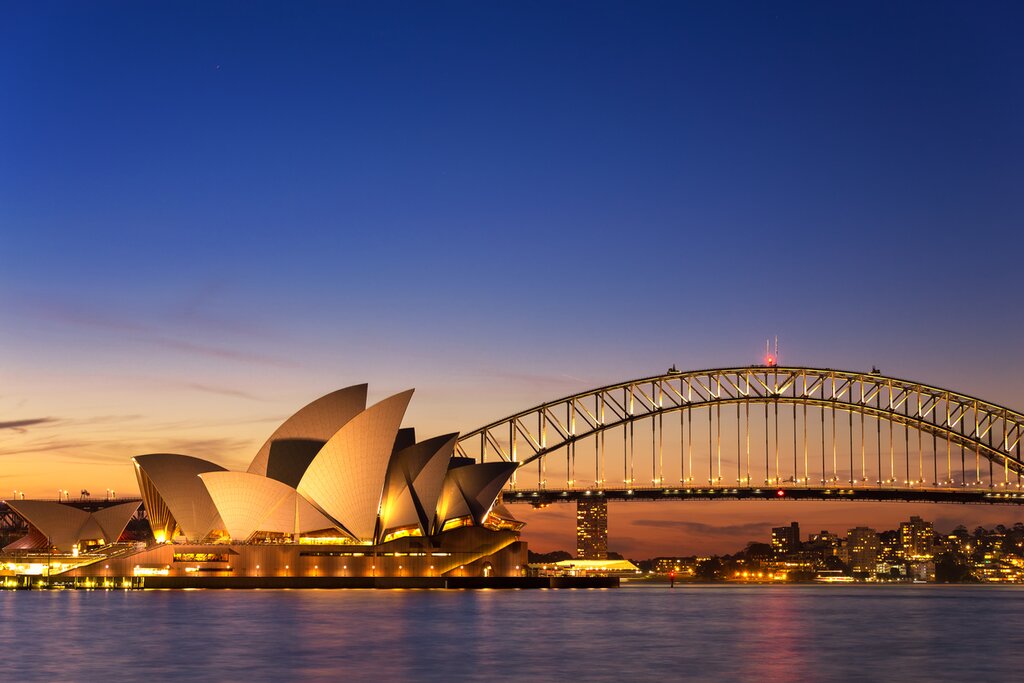 Australia, Sydney - Sydney Opera House and Harbour Bridge lit up at twilight.jpg