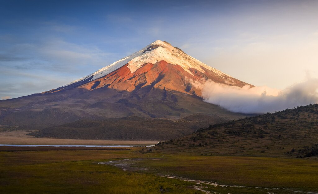 Cotopaxi Volcano at sunset surrounded by paramo landscape