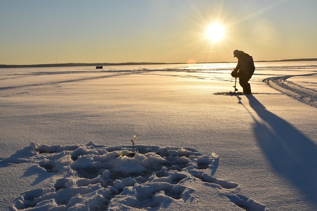 Ice fishing at sunset