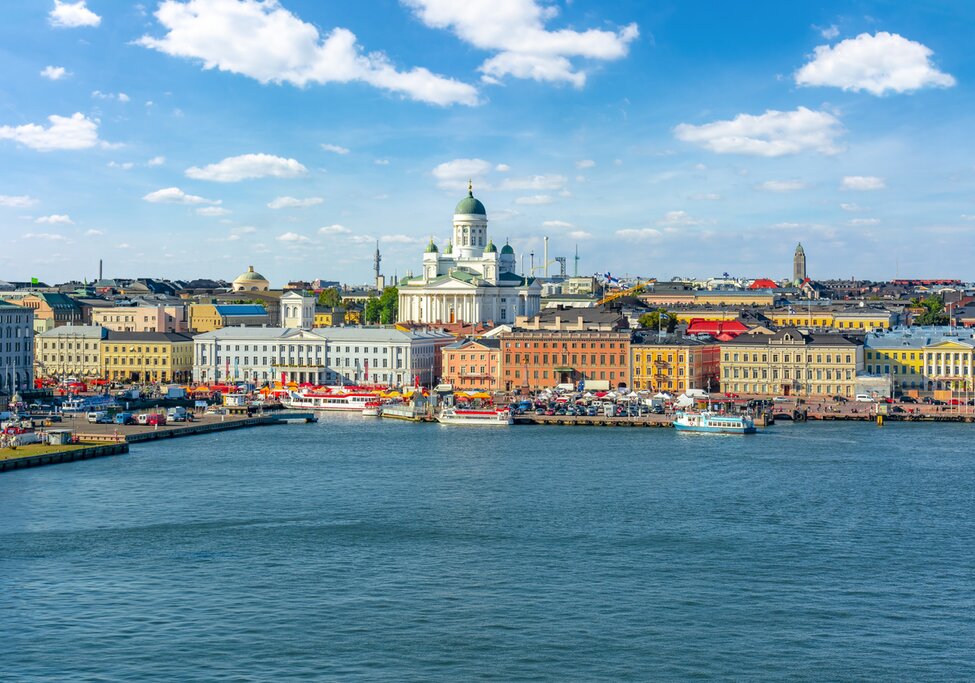 View across the water of Helsinki during a clear day. Helsinki Cathedral and the Market Square are clearly visible.