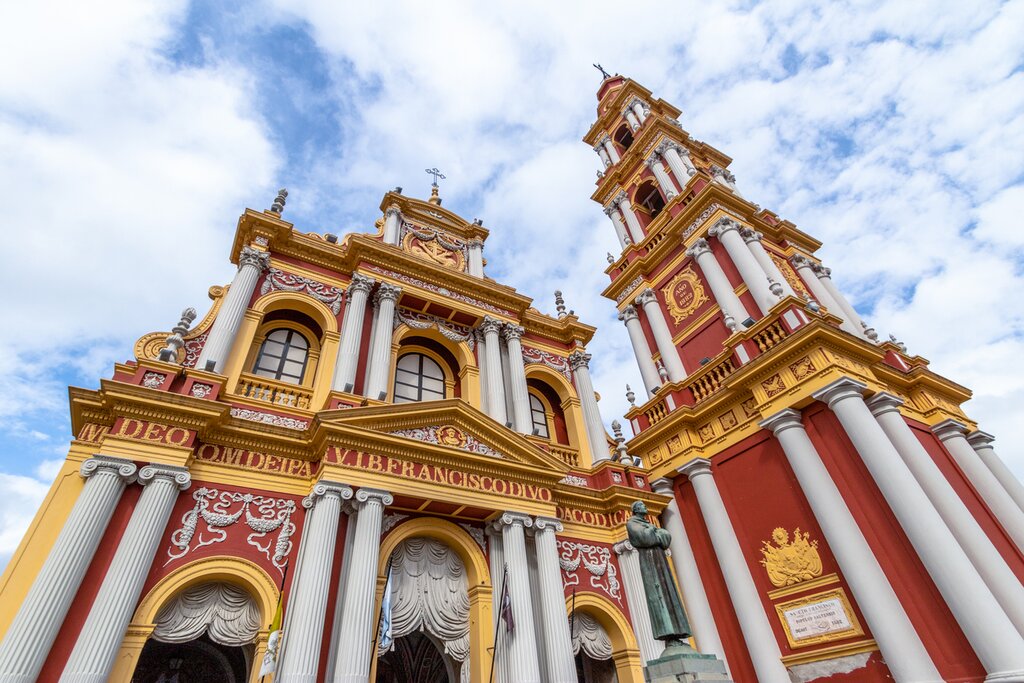 A view up from the foot of the red, white, and yellow San Francisco Church in Salta