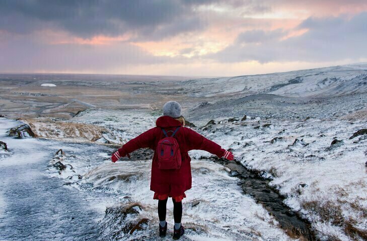 Young girl looking over Iceland's frozen landscapes