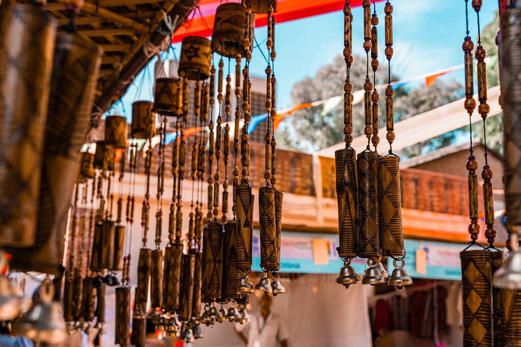 Wooden windchimes with musical bells for sale at Dilli Haat, an outdoor handicraft bazaar market in New Delhi India