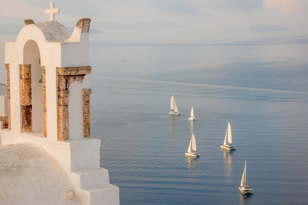 Sail along Santorini's coastline by private catamaran