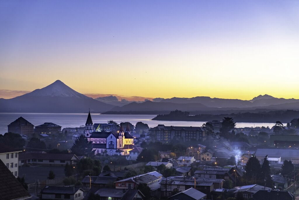 View of Puerto Varas, Chile, at sunrise with the Orsorno volcano in the distance