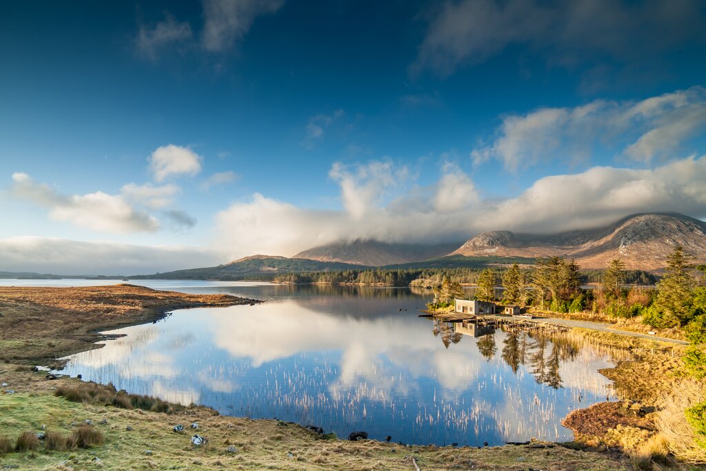 Clouds and hills reflected in a countryside lake