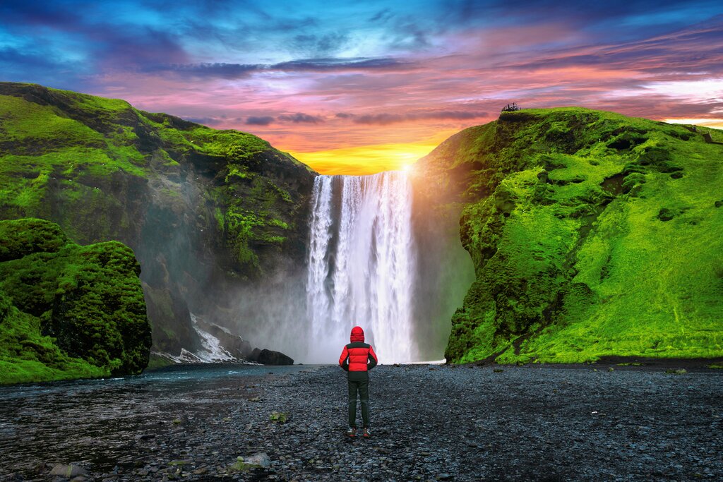 Experience natural wonders like Skógafoss on this adventure-filled luxury trip