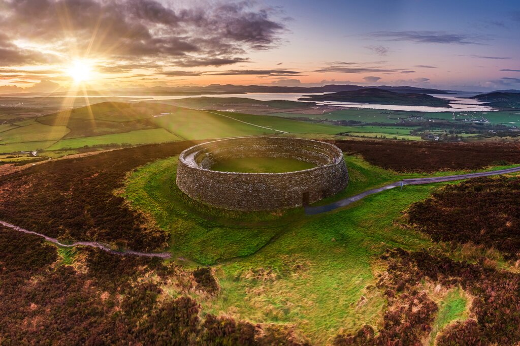 Grianan of Aileach ring fort surrounded by hills at sunset