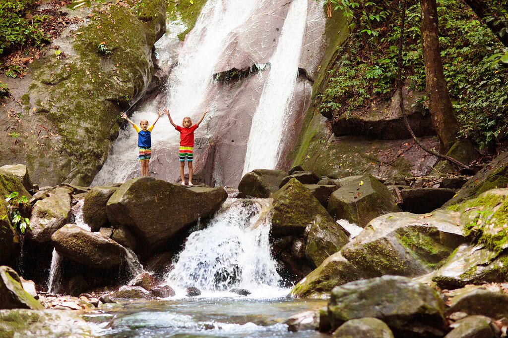Boys trekking in the jungle to waterfalls
