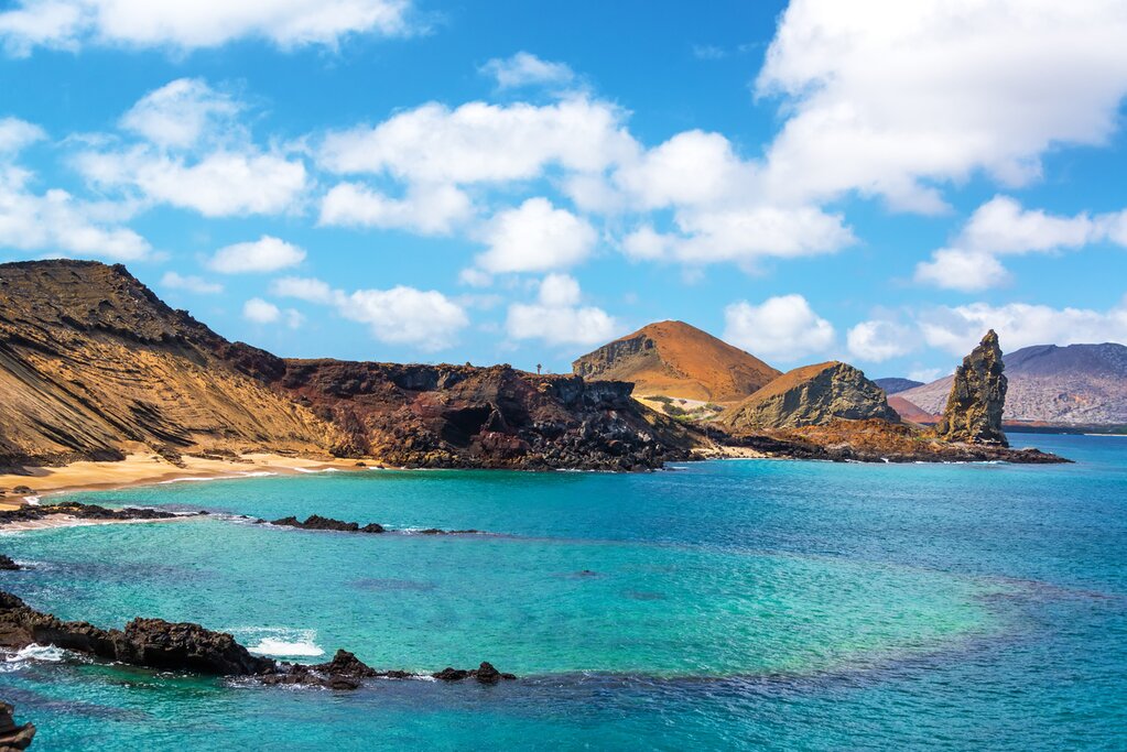 View of an underwater crater in the foreground with Pinnacle Rock in the background on Bartolome Island in the Galapagos Islands