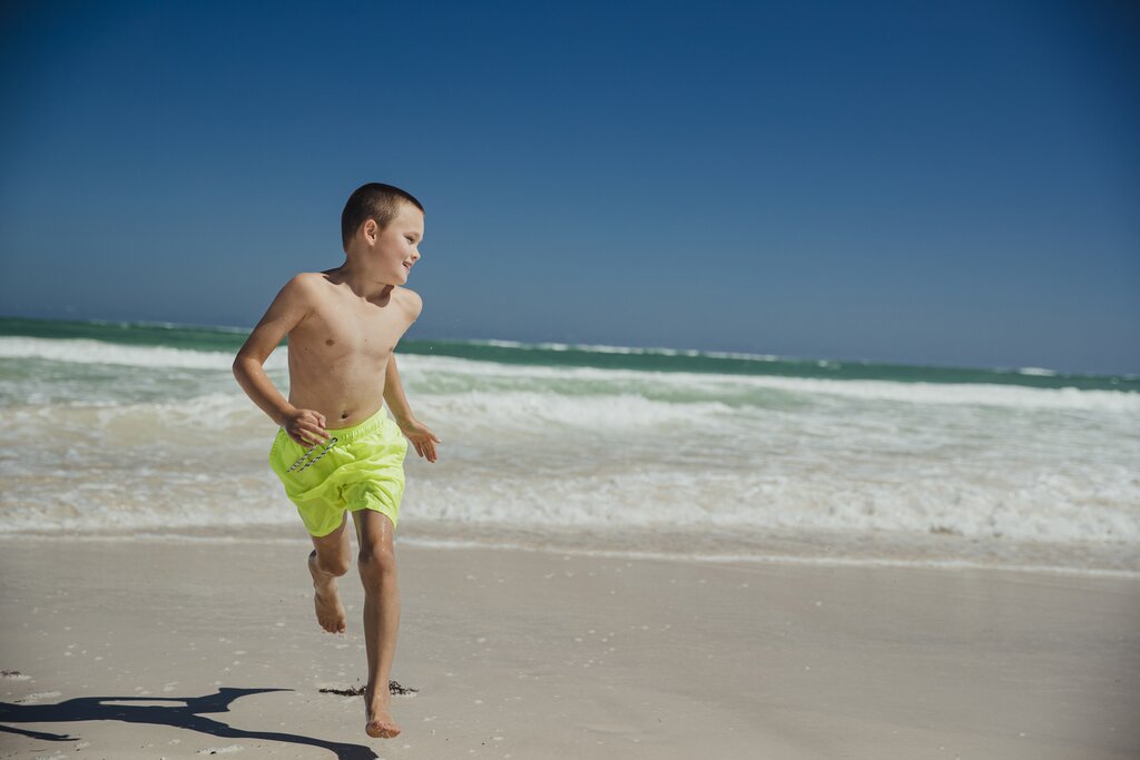 Boy running on the beach in Perth, Australia