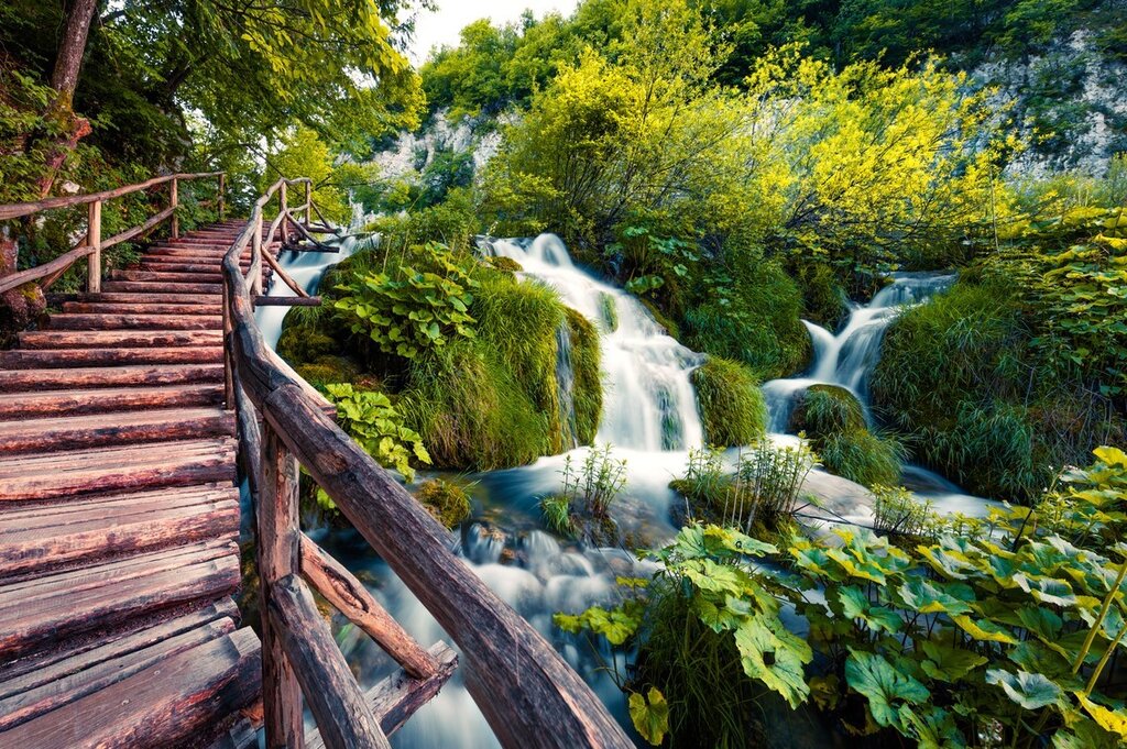 Follow boardwalks and trails through the lakes and waterfalls of Plitvice Lakes National Park